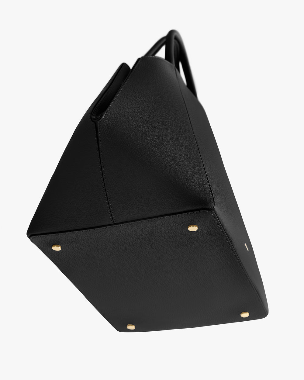 Tote bag with four metal feet and a structured design.
