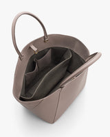 Open handbag showing interior pockets and handles.