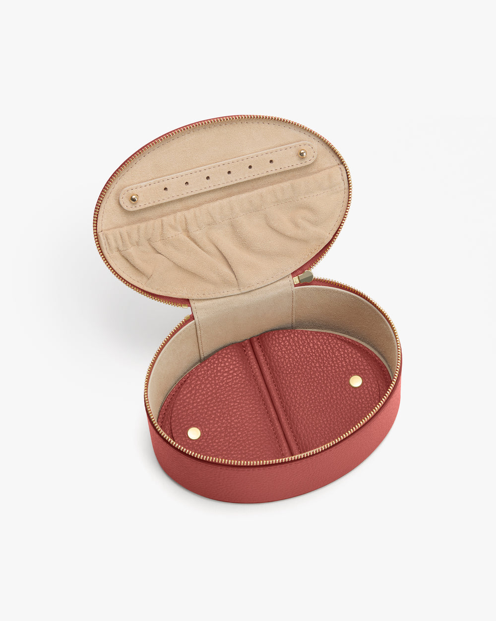 Round jewelry case with open zippered lid, revealing interior compartments.