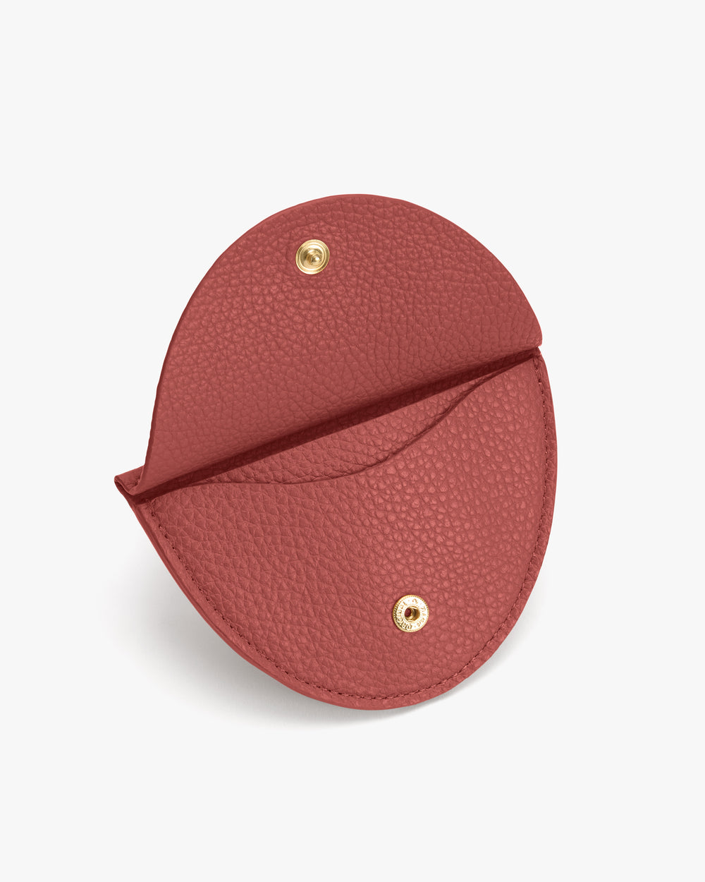 Round leather coin pouch with snap closure, open to show interior.