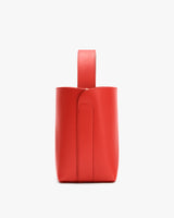 Rectangular handbag with a single handle shown from the side.