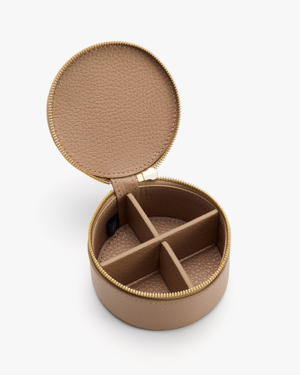 Round jewelry case with open lid and four compartments.