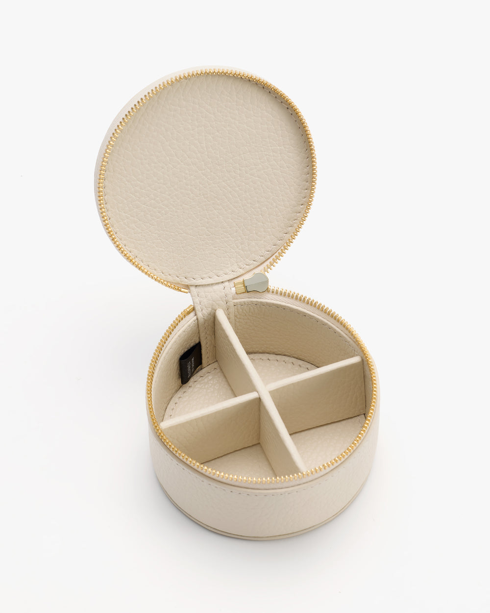 Round jewelry case with open lid and compartments inside.