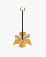 Leather flower keychain with a circular metal ring at the top.