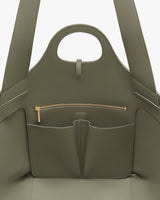 Open handbag with pockets and zipper visible inside.