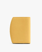 Textured wallet standing upright against a plain background.