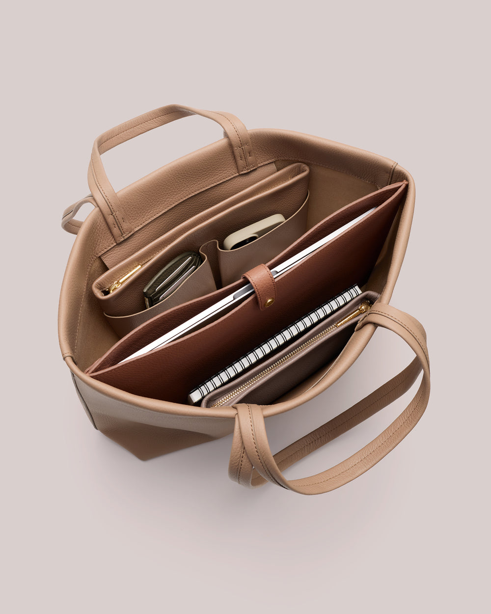 Open tote bag with organized compartments and items inside.