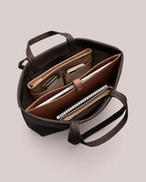 Open tote bag with organized compartments and accessories inside.