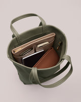 Open tote bag with laptop, notebook, and wallet inside.