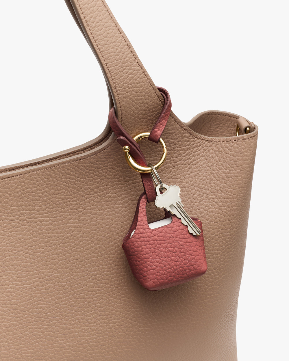 Handbag with a small leather keychain holder attached.
