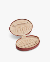 Open oval jewelry case with compartments and zipper closure.