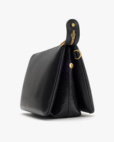 Handbag with croc-embossed leather trim and decorative fastener