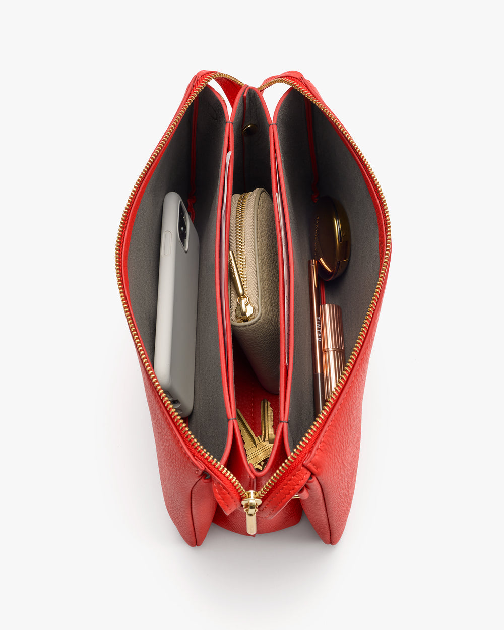 Bag with phone, wallet, and sunglasses inside, showing open compartments.