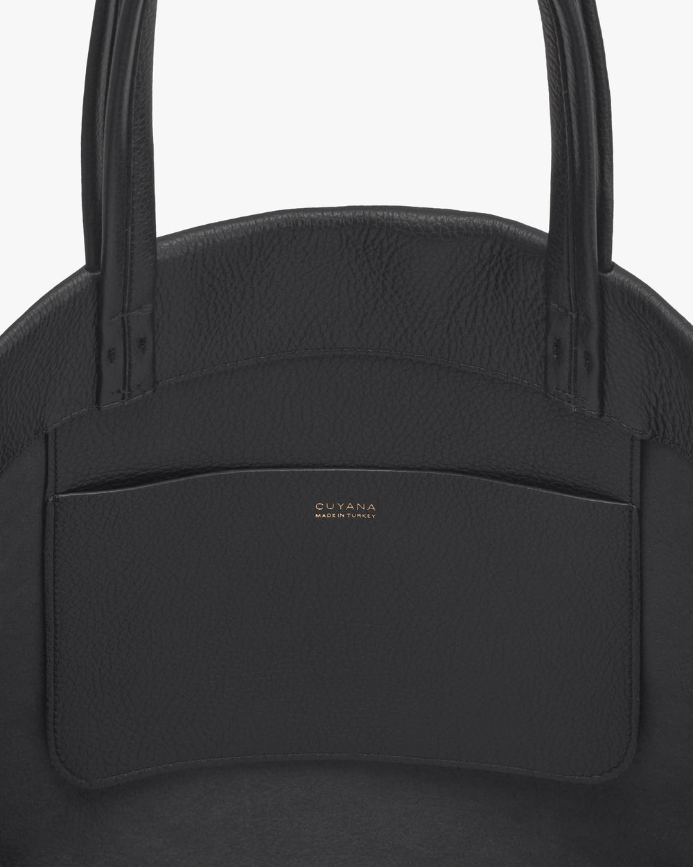 Close-up of a structured handbag with a pocket and two handles.