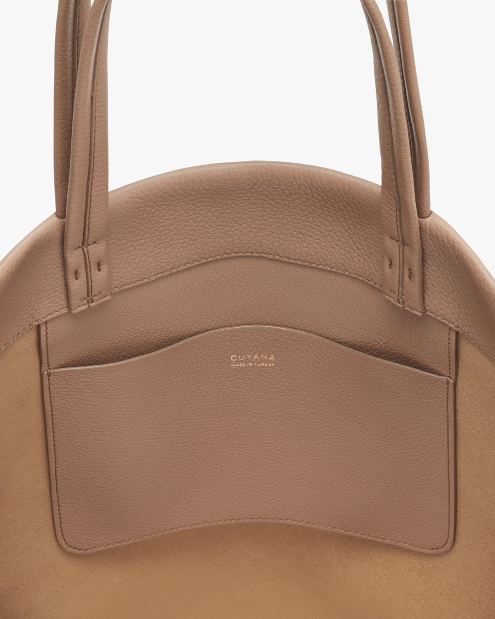 Round bag with a front pocket and two handles.