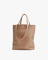 Tote bag with two handles on a plain background.