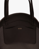 Close-up of a tote bag with visible pocket and handles.