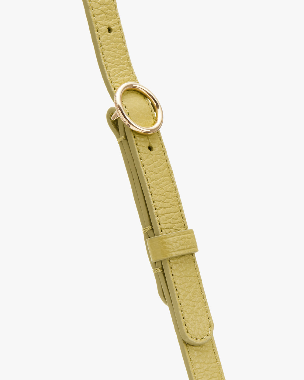 Close-up of a textured strap with a circular metal buckle.