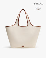 Large tote bag with thin handles on display.