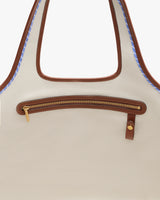 Tote bag with a front zipper pocket and brown accents