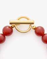 Beaded necklace with a circular clasp labeled Cuyana.