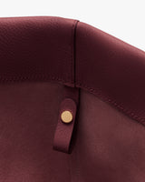 Close-up of a leather bag interior with a small button detail.