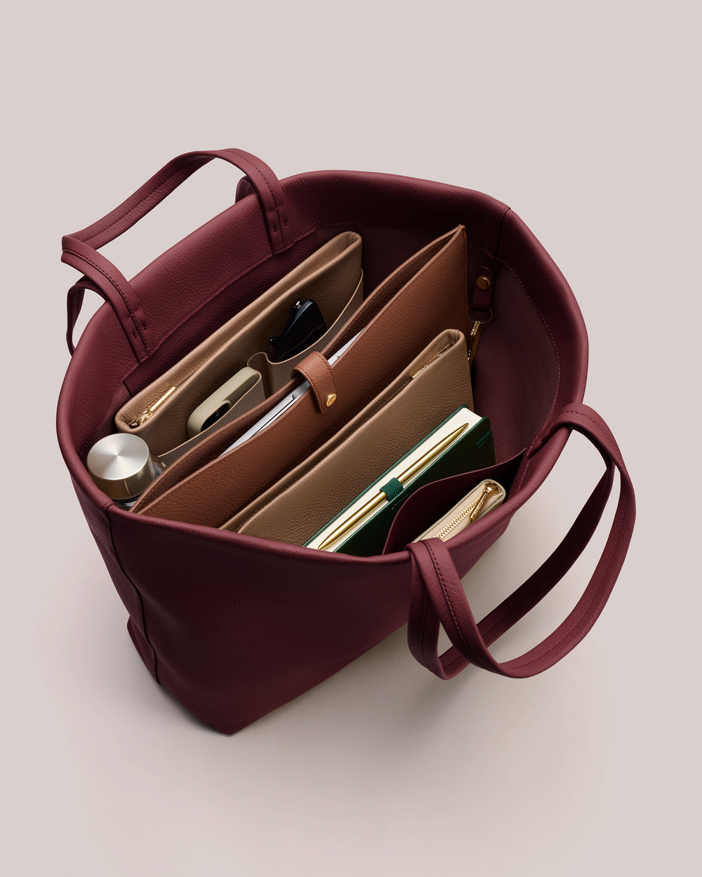 Open tote bag with organized items inside.