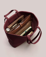 Open tote bag with organized items inside.