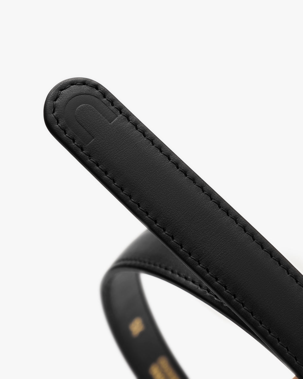 Close-up of a leather belt with a stitched edge detail.