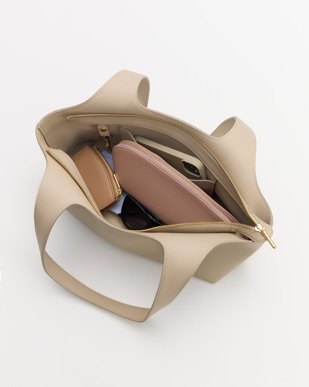 Open handbag displaying wallet, sunglasses, and pouch inside.