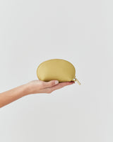 Hand holding a small zippered pouch.