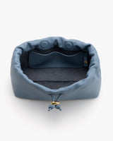 Open drawstring bag with interior pocket and small button closure.