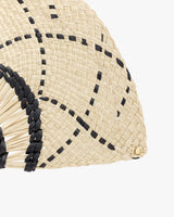 Close-up of a woven pattern clutch bag with black accents.
