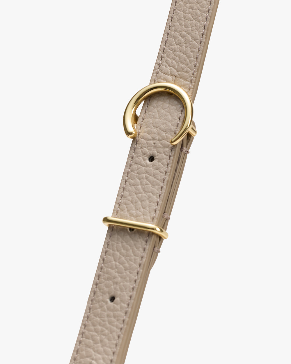Bag strap with gold buckle display