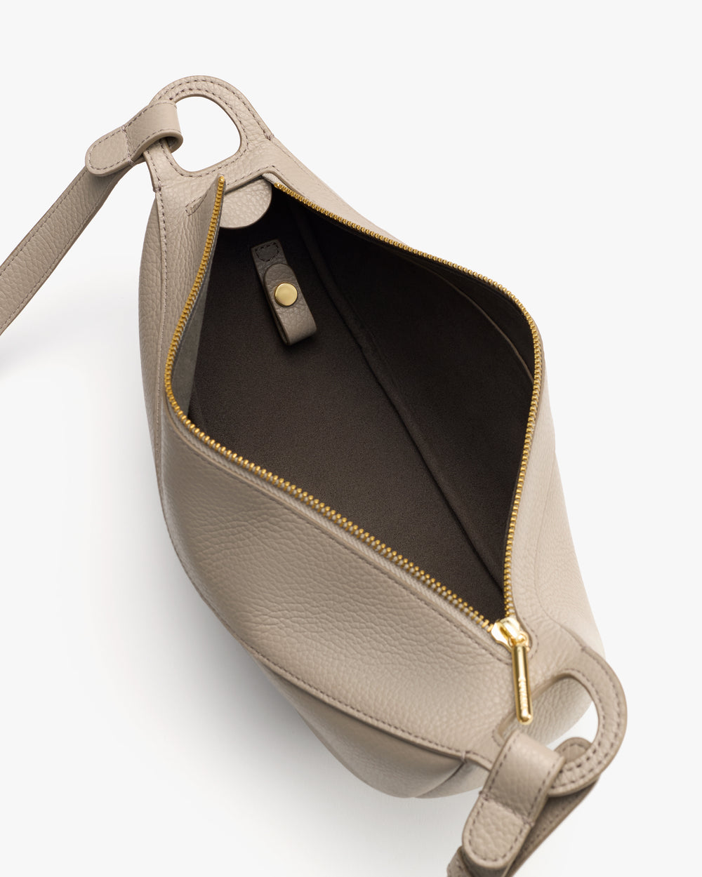Open handbag with a visible interior zipper and a snap closure.