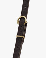 Close-up of a textured belt with metallic buckles and loops.