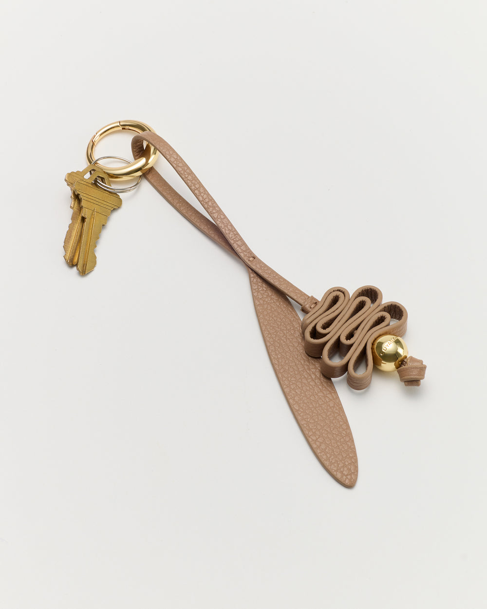 Keychain with keys and decorative looped leather strap attached.