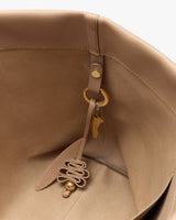 Interior of a bag with attached keychain and decorative charm.