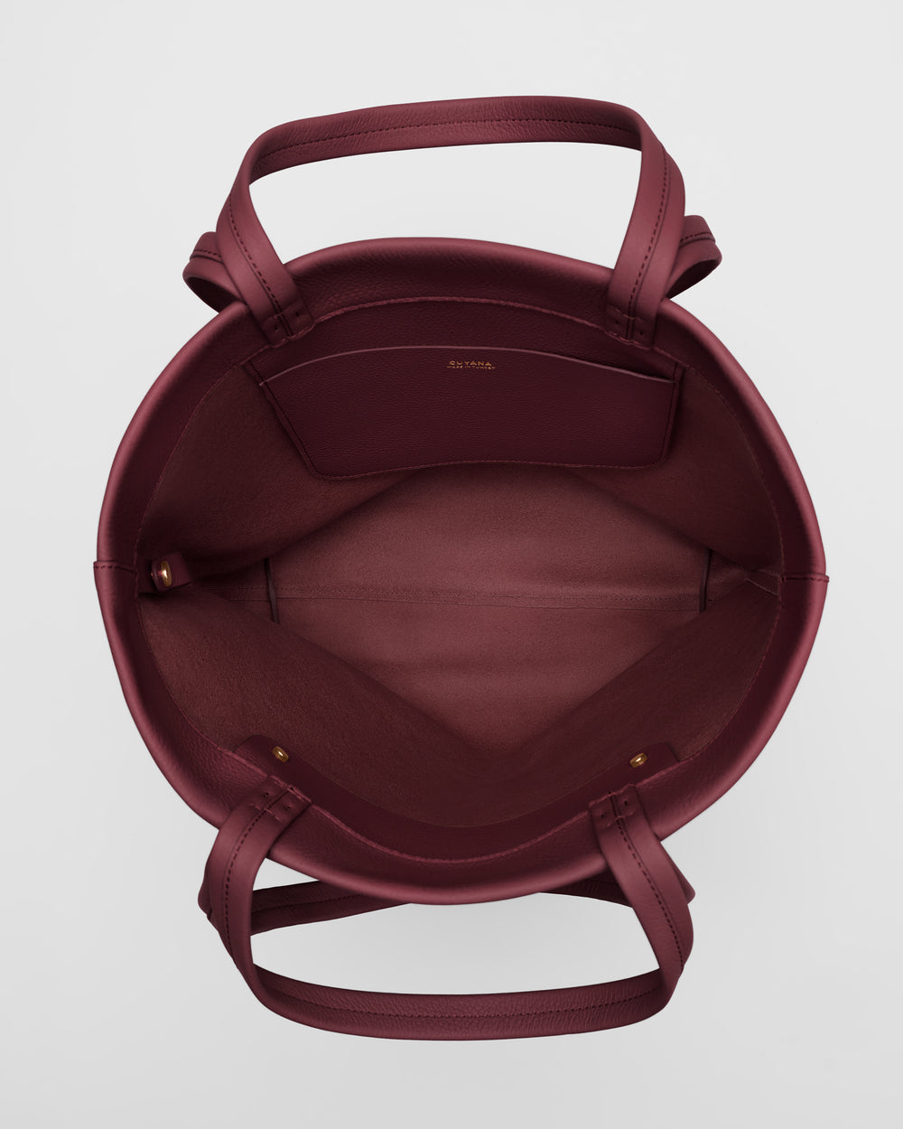 Open tote bag with handles and pocket inside.