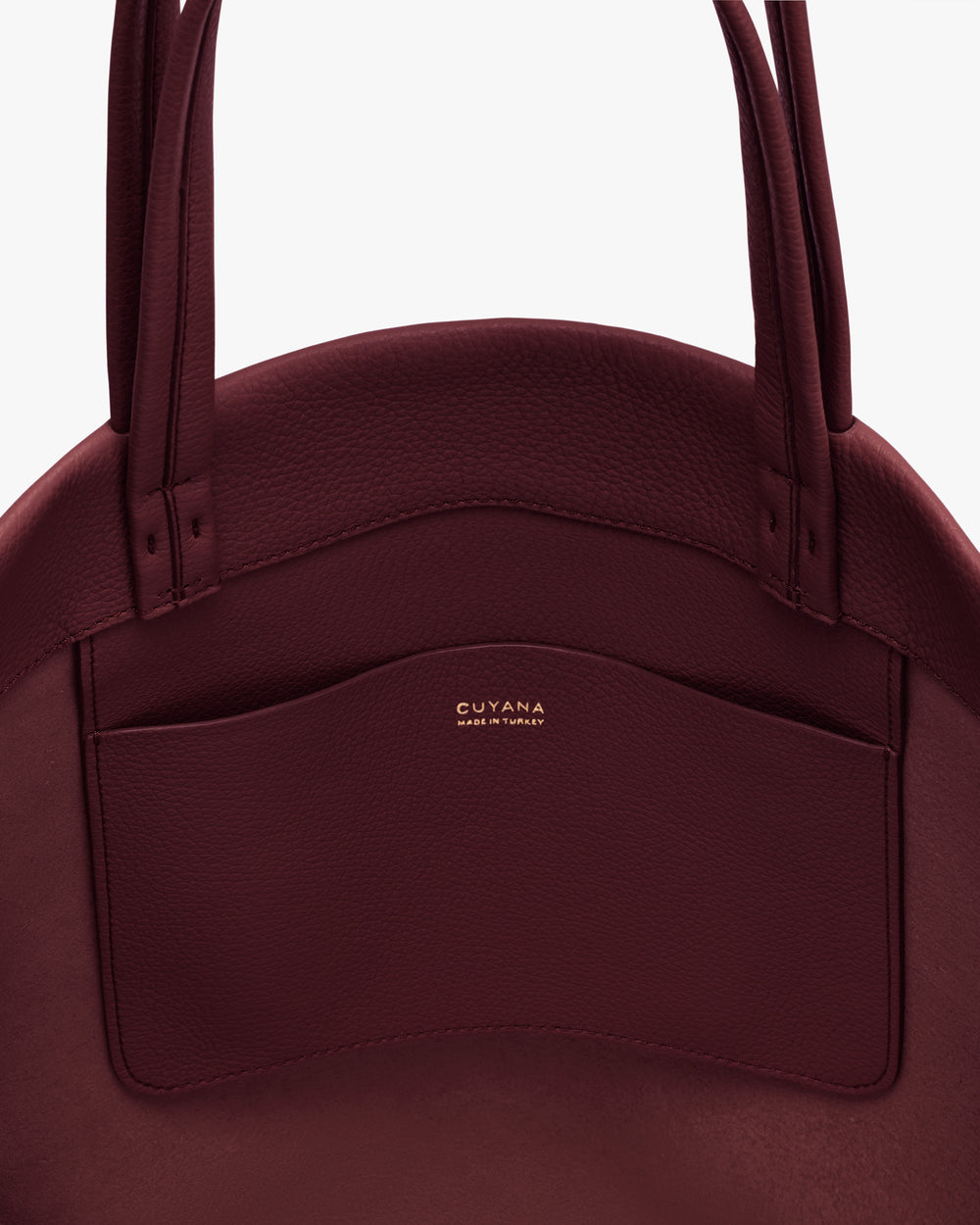 Round bag with long handles and an exterior pocket.