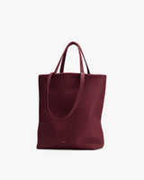 Large tote bag with dual handles standing upright.