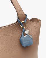 Handbag with a small keychain holder attached.