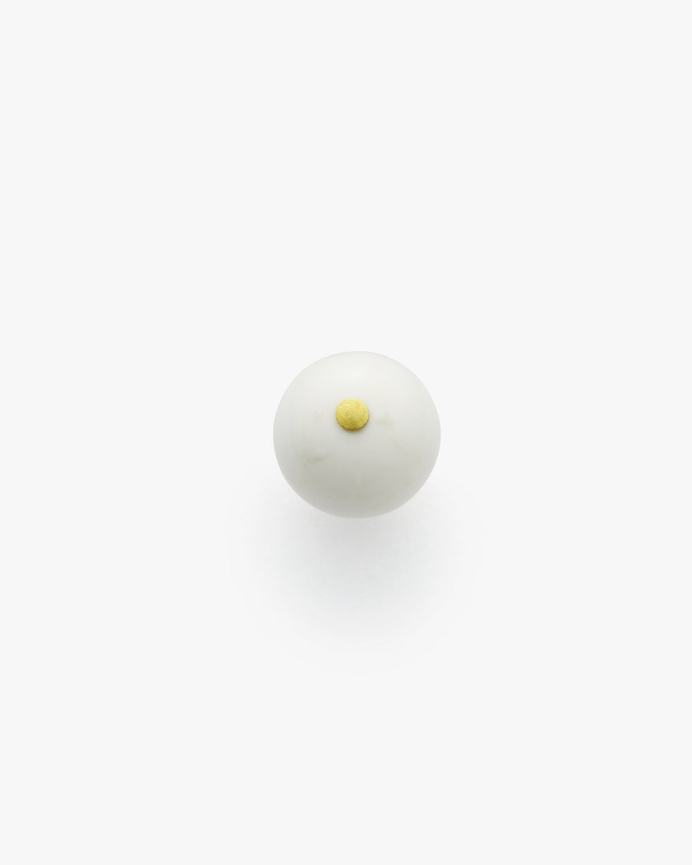 Round object with a small raised circular detail on top.