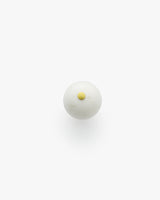 Round object with a small raised circular detail on top.