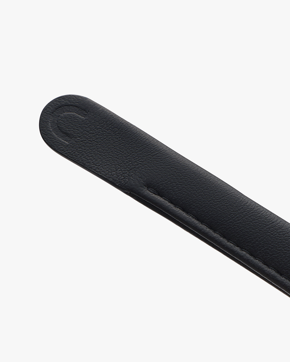 Close-up of a leather strap with embossed detail.