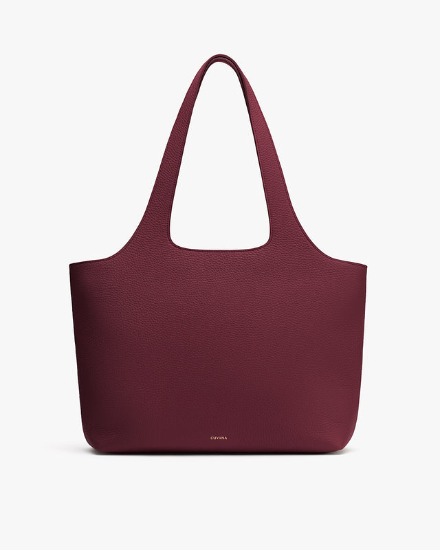 Large tote bag with shoulder straps on plain background