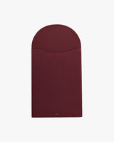 Rectangular leather laptop sleeve with a curved flap closure.