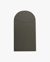 Rectangular leather laptop sleeve with a curved flap closure.