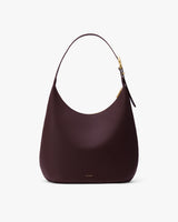 Curved bag with a single strap and curved top.