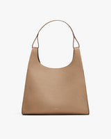 Handbag with a single strap and a textured surface, displayed against a plain background.